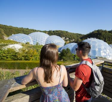 Couple looking out at Biomes on a sunny day